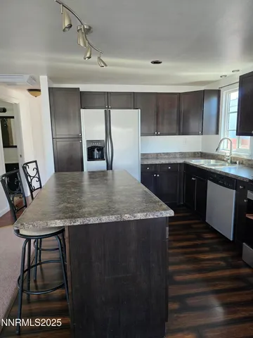 a kitchen with a stove a sink and a refrigerator
