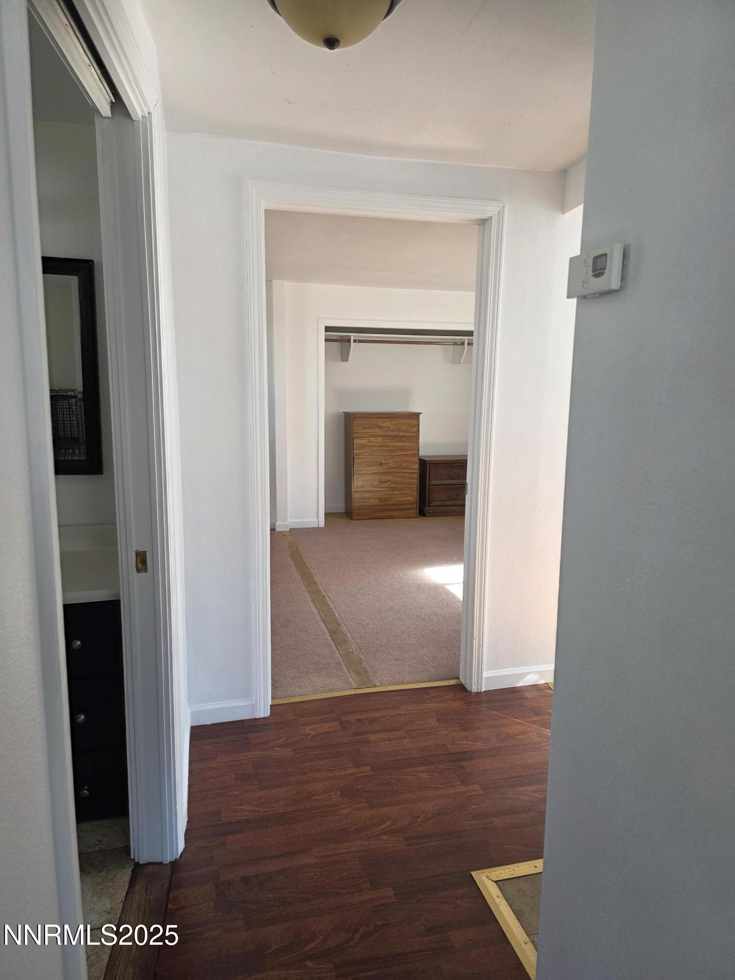 1110 4th Street Hawthorne, NV 89415 - Photo 18 of 27 a view of a hallway with wooden floor and closet