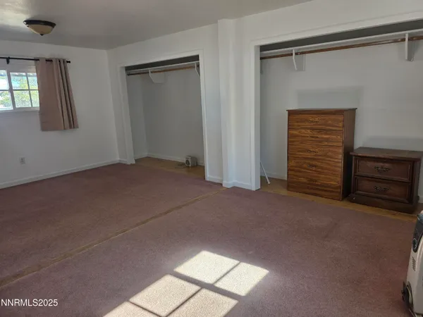 a view of an empty room and a window