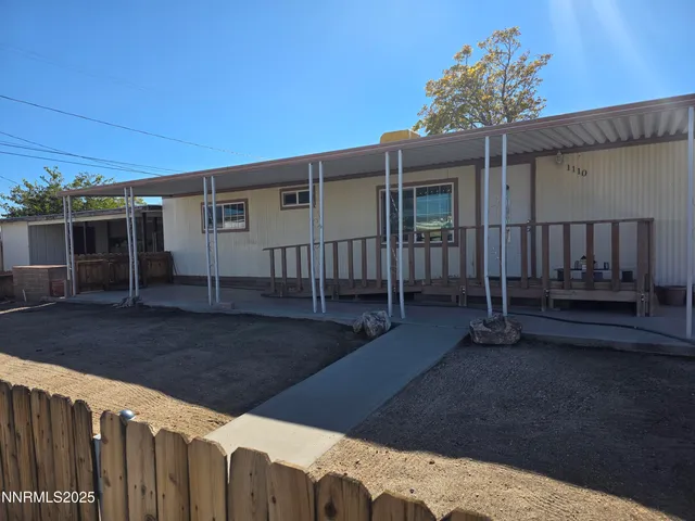 a view of a house with wooden fence