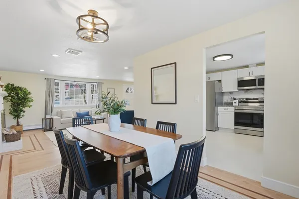 a view of a dining room with furniture and wooden floor