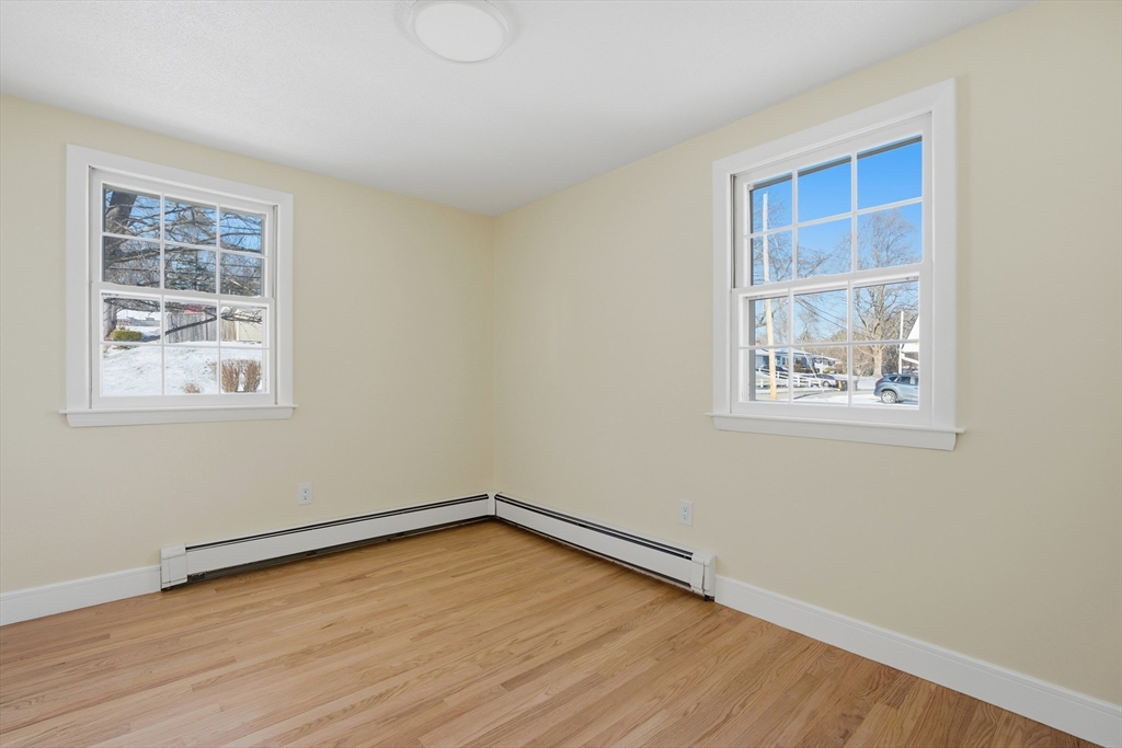 108 Cherry Street Framingham, MA 01701 - Photo 12 of 30 a view of an empty room with wooden floor and a window