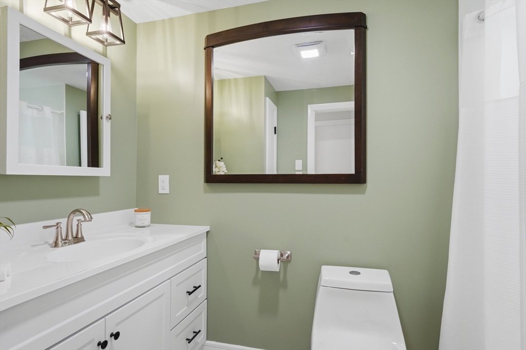 108 Cherry Street Framingham, MA 01701 - Photo 15 of 30 a bathroom with a toilet sink and mirror