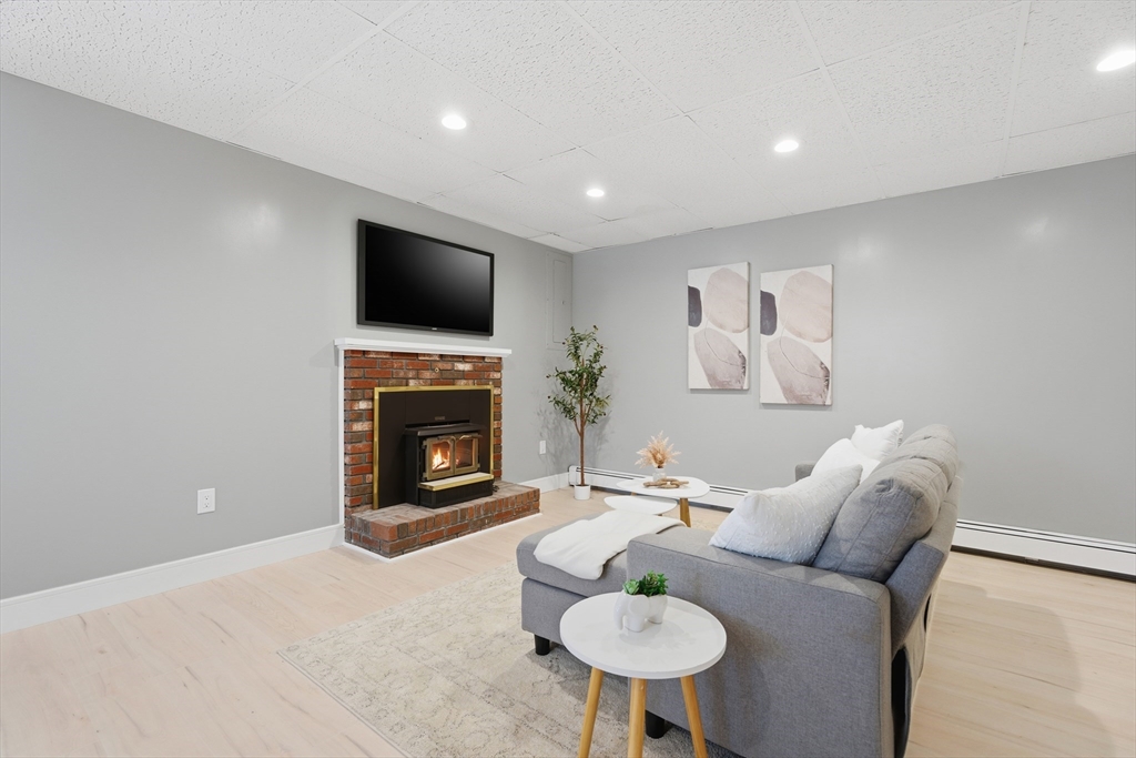 108 Cherry Street Framingham, MA 01701 - Photo 19 of 30 a living room with furniture a flat screen tv and a fireplace