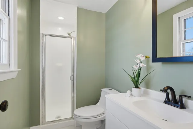 a bathroom with a sink a toilet and a mirror