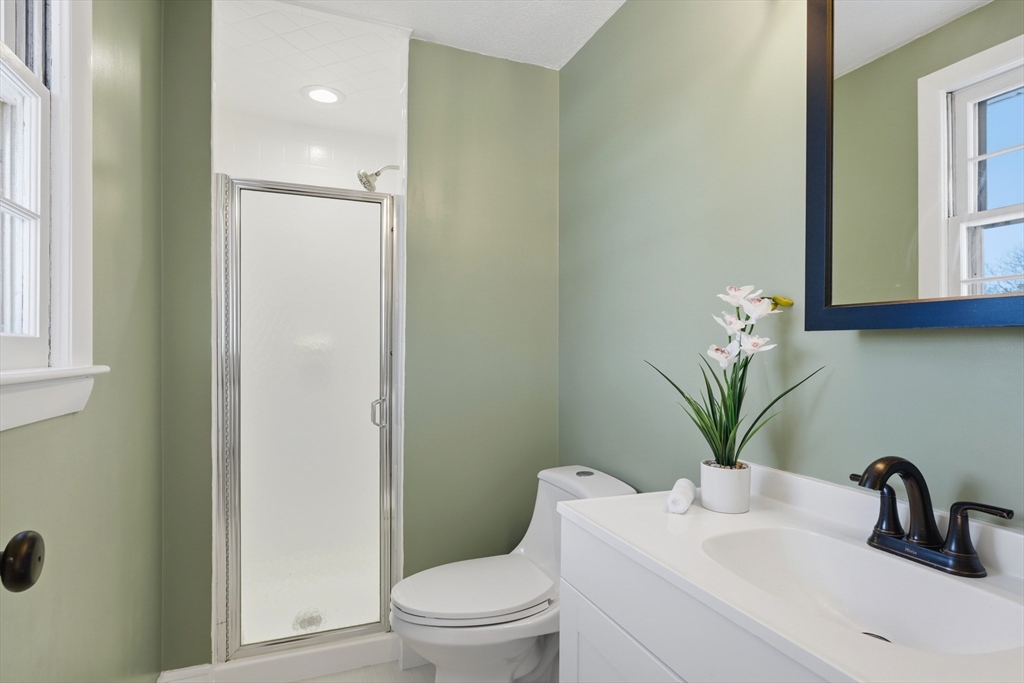 108 Cherry Street Framingham, MA 01701 - Photo 10 of 30 a bathroom with a sink a toilet and a mirror