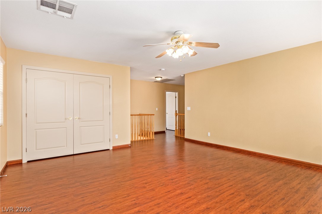 1477 Rancho Ridge Drive Henderson, NV 89012 - Photo 28 of 46 Rich hardwood-style flooring extends through this generously sized bonus room, offering flexible living space.