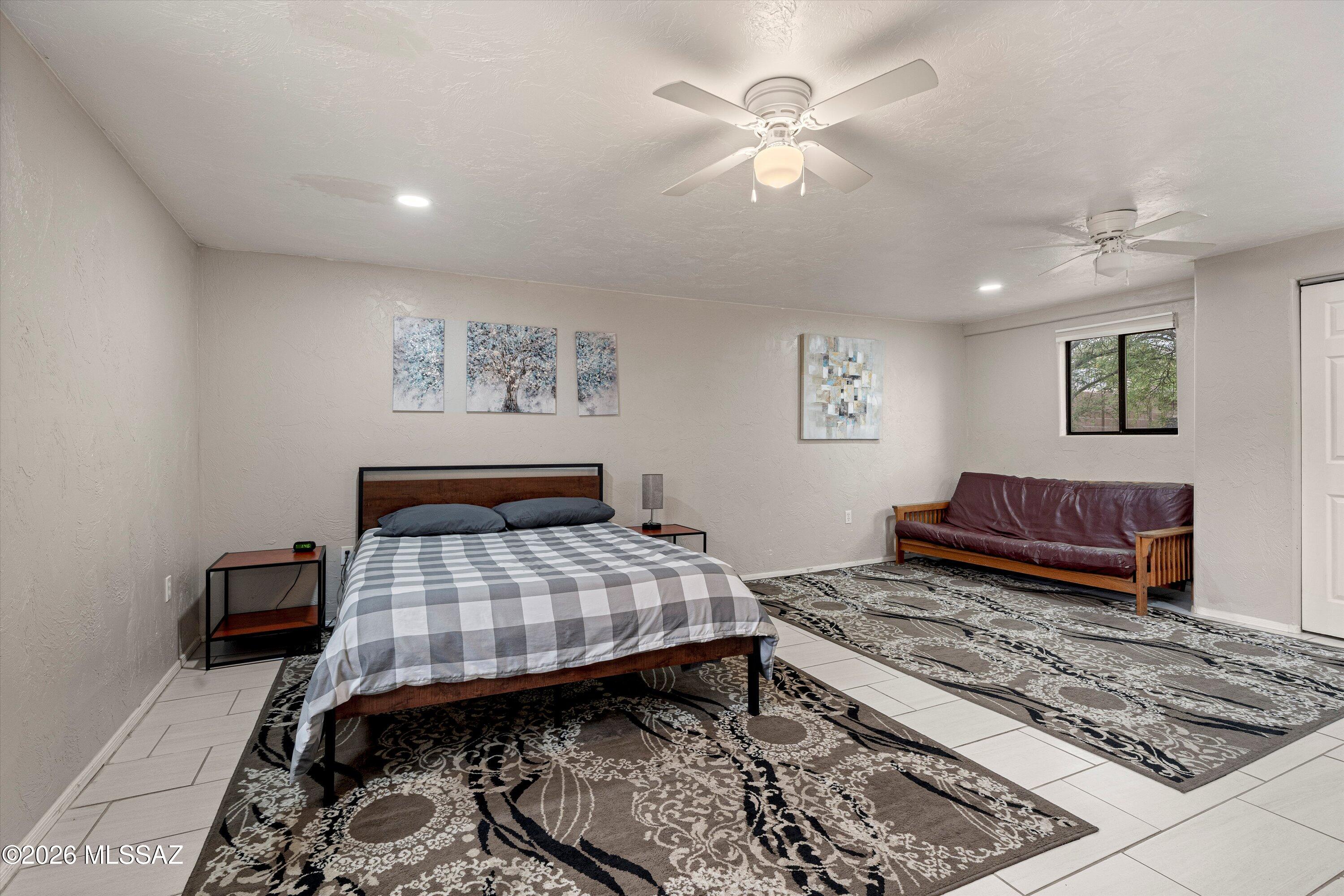 2841 North Richey Boulevard Tucson, AZ 85716 - Photo 14 of 30 a bedroom with a bed and wooden floor