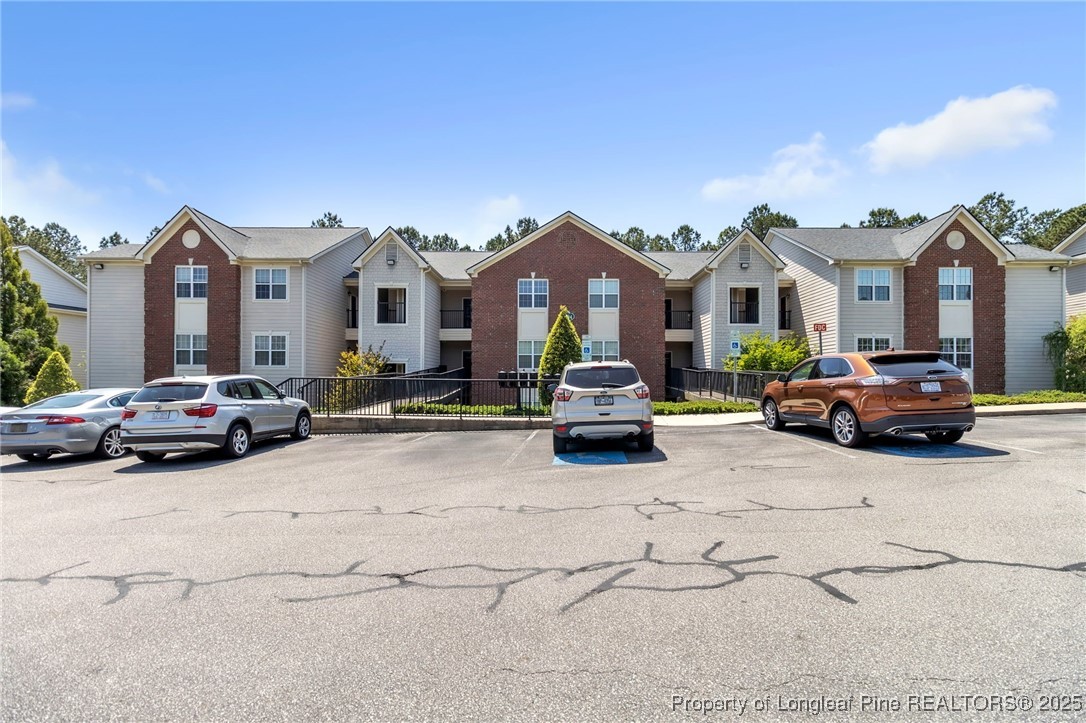 124 Gallery Drive, Unit 302 Spring Lake, NC 28390 - Photo 1 of 33 a view of a city street with a car parked in front of it