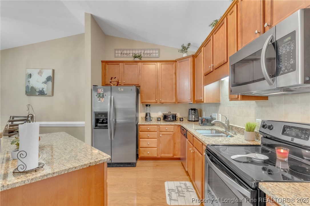 124 Gallery Drive, Unit 302 Spring Lake, NC 28390 - Photo 12 of 33 a kitchen with stainless steel appliances granite countertop a sink dishwasher stove refrigerator and cabinets with wooden floor