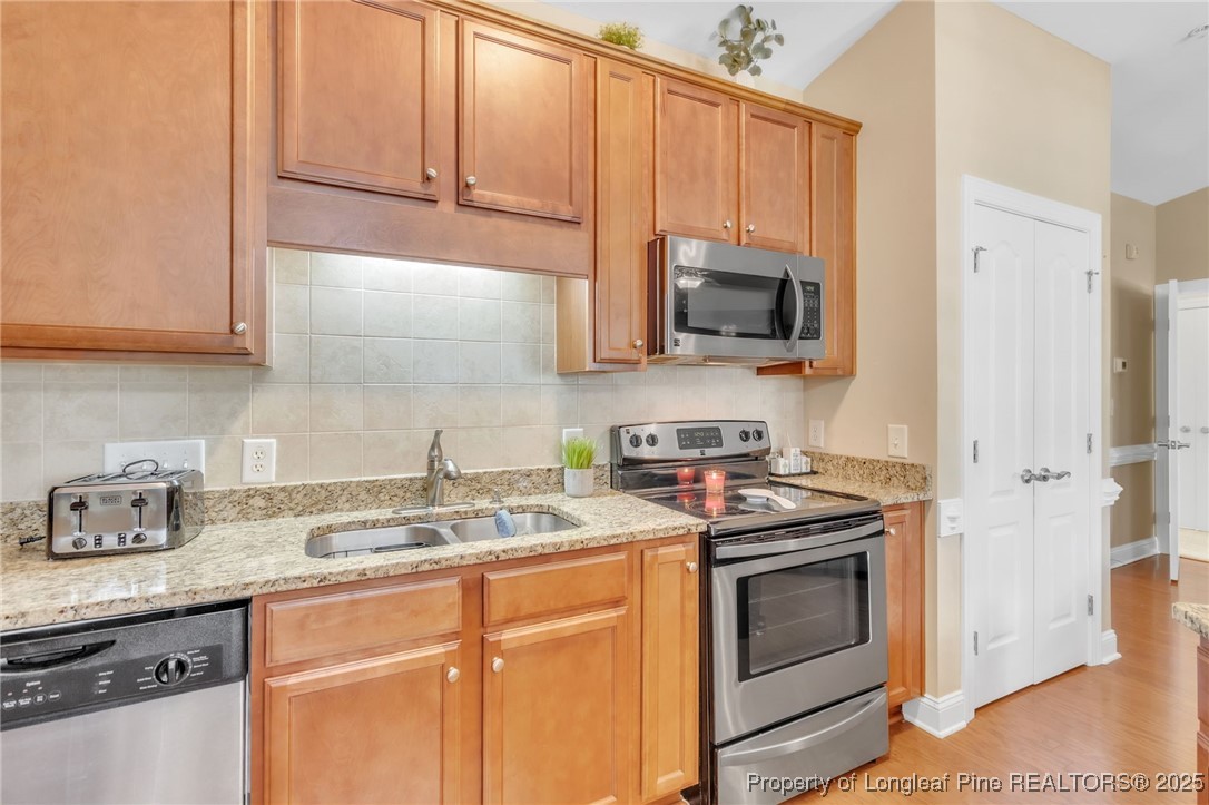 124 Gallery Drive, Unit 302 Spring Lake, NC 28390 - Photo 14 of 33 a kitchen with granite countertop cabinets stainless steel appliances and a sink