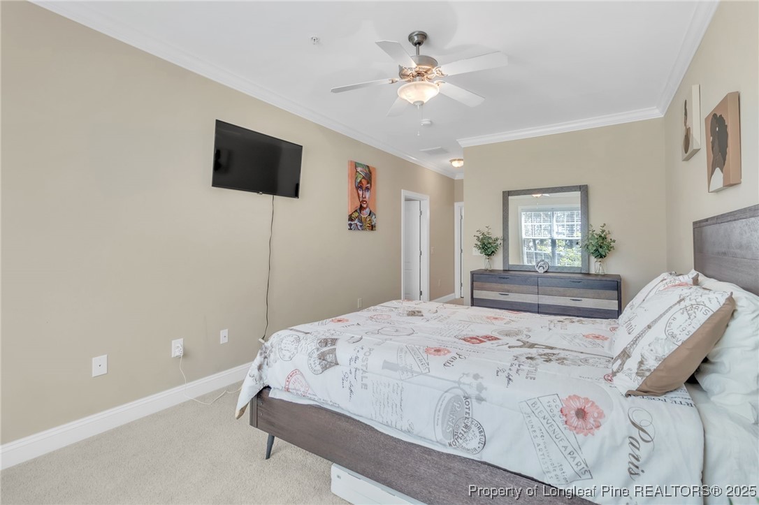 124 Gallery Drive, Unit 302 Spring Lake, NC 28390 - Photo 17 of 33 a spacious bedroom with a bed and a flat screen tv