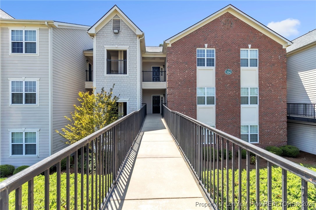 124 Gallery Drive, Unit 302 Spring Lake, NC 28390 - Photo 2 of 33 a front view of a house with a balcony