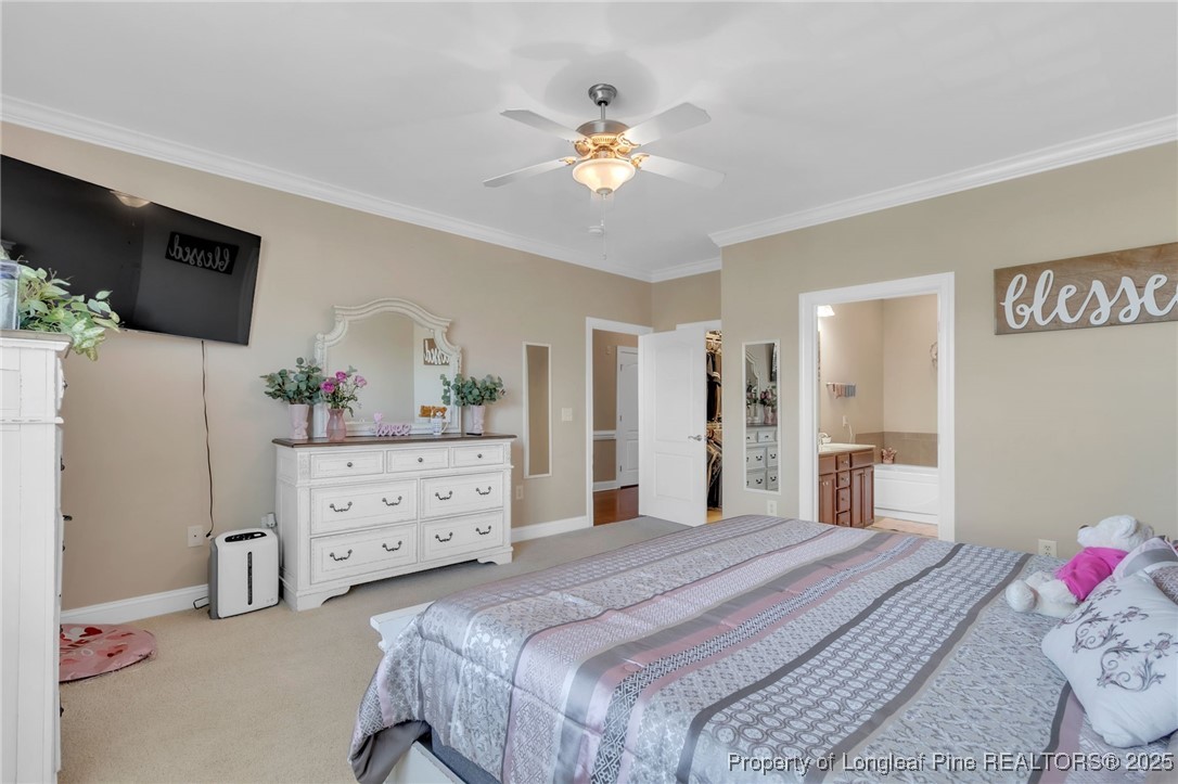 124 Gallery Drive, Unit 302 Spring Lake, NC 28390 - Photo 23 of 33 a bedroom with a bed and a chandelier