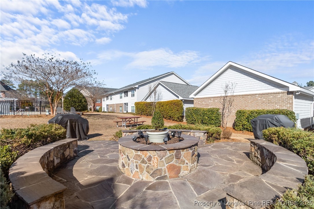 124 Gallery Drive, Unit 302 Spring Lake, NC 28390 - Photo 31 of 33 a backyard of a house with table and chairs
