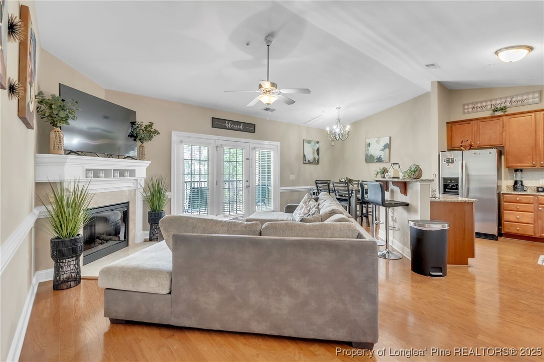 124 Gallery Drive, Unit 302 Spring Lake, NC 28390 - Photo 6 of 33 a living room with furniture a fireplace and a kitchen view