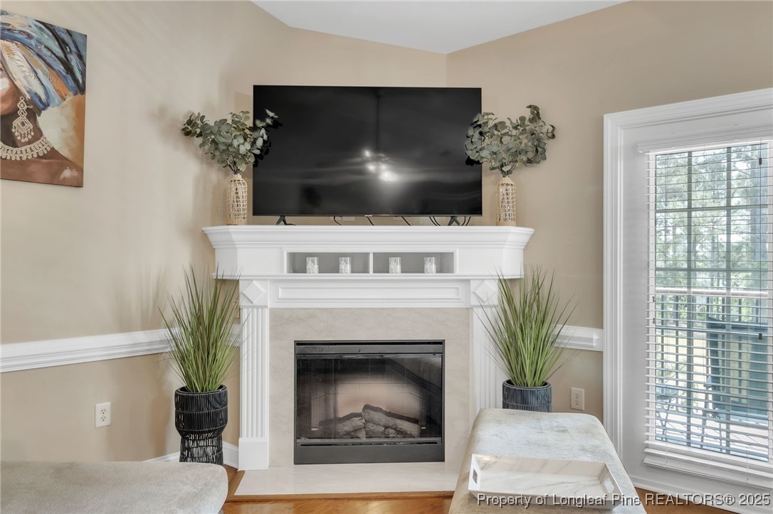 124 Gallery Drive, Unit 302 Spring Lake, NC 28390 - Photo 7 of 33 a living room with a fireplace and a potted plant
