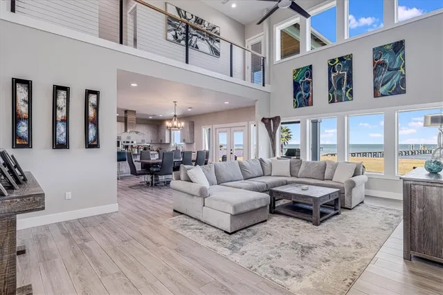 a kitchen with stainless steel appliances kitchen island granite countertop a table chairs in it and wooden floors