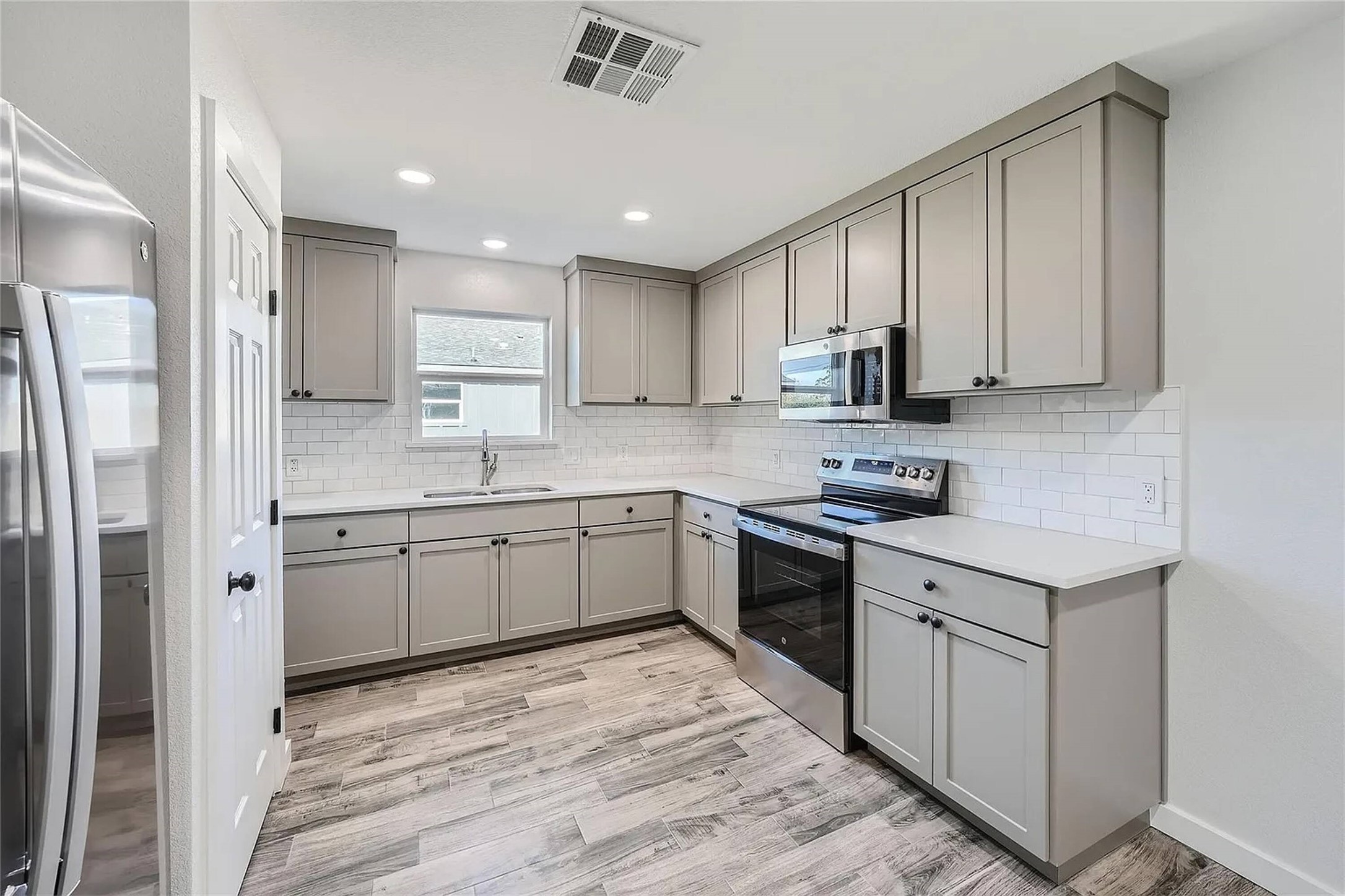 109 Fisher Street, Unit A & B Elgin, TX 78621 - Photo 3 of 9 a kitchen with stainless steel appliances granite countertop a stove a sink and a refrigerator