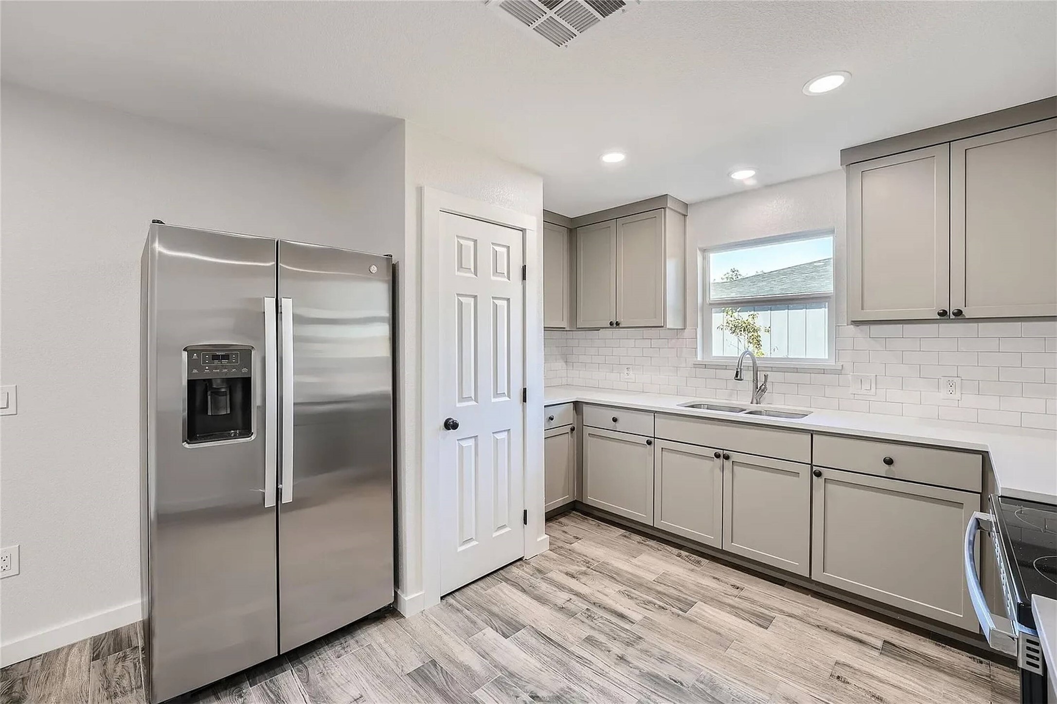 109 Fisher Street, Unit A & B Elgin, TX 78621 - Photo 6 of 9 a kitchen with stainless steel appliances granite countertop a refrigerator and a sink