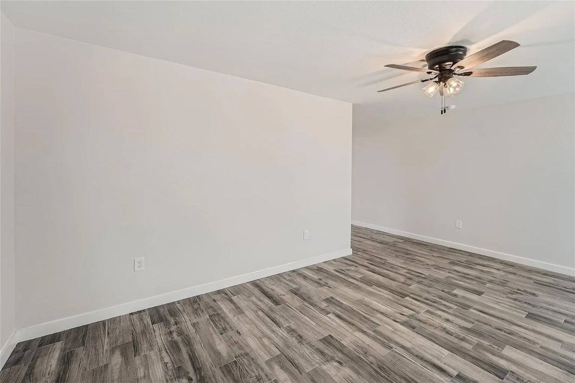 109 Fisher Street, Unit A & B Elgin, TX 78621 - Photo 7 of 9 Spare room featuring a ceiling fan and wood finished floors
