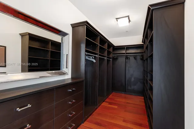 a hallway with a large window and cabinets