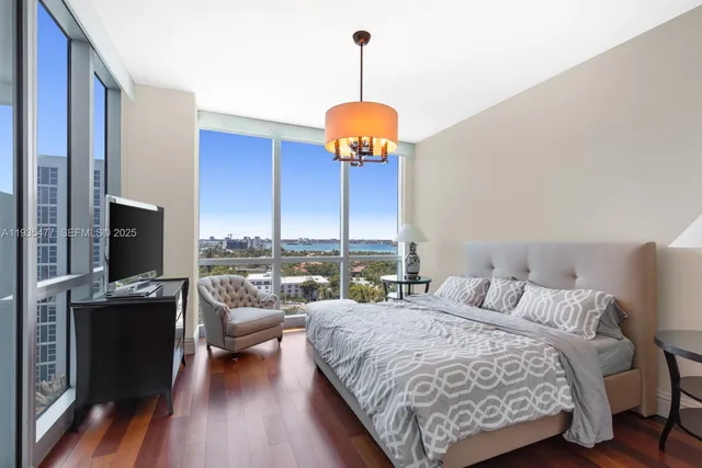 a bedroom with a bed and a chandelier
