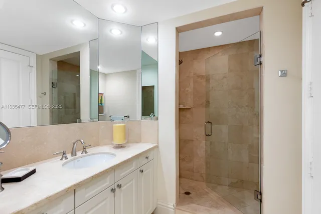 a bathroom with a shower sink and mirror