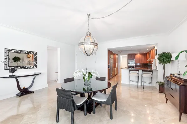 a view of a dining room with furniture and a potted plant