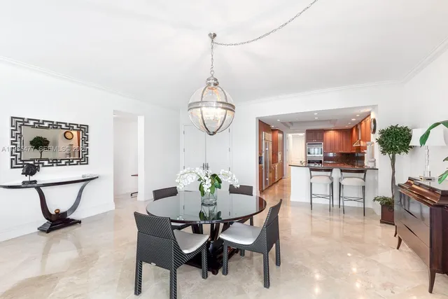 a view of a dining room with furniture and a potted plant