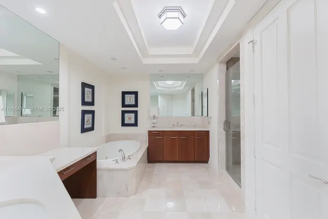 a spacious bathroom with a bathtub sink mirror and toilet