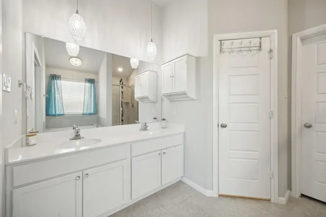 a bathroom with a sink a light fixture a vanity and a mirror