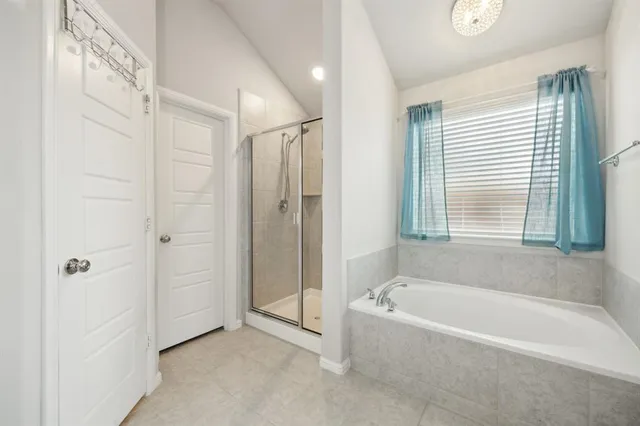 a spacious bathroom with a bathtub and shower