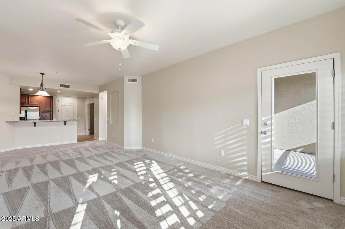 5450 East Deer Valley Drive, Unit 2024 Phoenix, AZ 85054 - Photo 15 of 50 an empty room with a mirror and fan