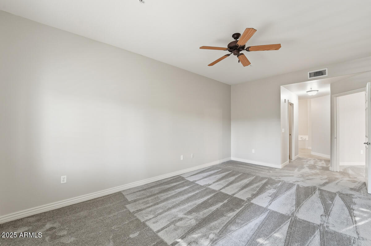 5450 East Deer Valley Drive, Unit 2024 Phoenix, AZ 85054 - Photo 24 of 50 a view of a room with a ceiling fan and a window
