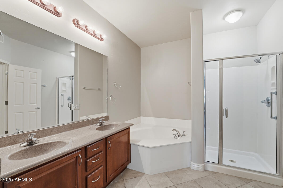5450 East Deer Valley Drive, Unit 2024 Phoenix, AZ 85054 - Photo 26 of 50 a bathroom with a bathtub double vanity and a sink