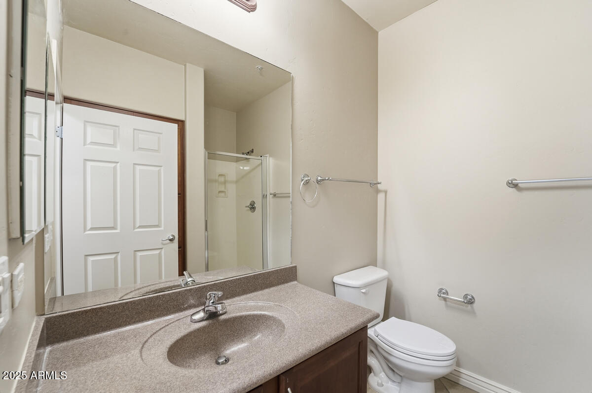 5450 East Deer Valley Drive, Unit 2024 Phoenix, AZ 85054 - Photo 31 of 50 a bathroom with a sink toilet and a mirror