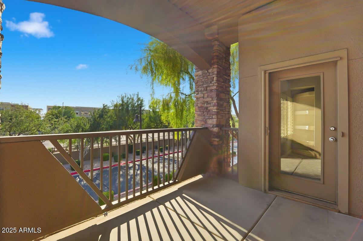 5450 East Deer Valley Drive, Unit 2024 Phoenix, AZ 85054 - Photo 34 of 50 a view of a balcony with a floor to ceiling window and wooden fence