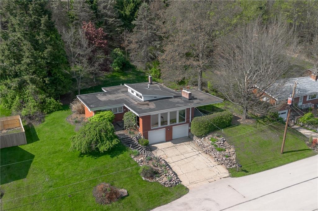 an aerial view of a house with a big yard