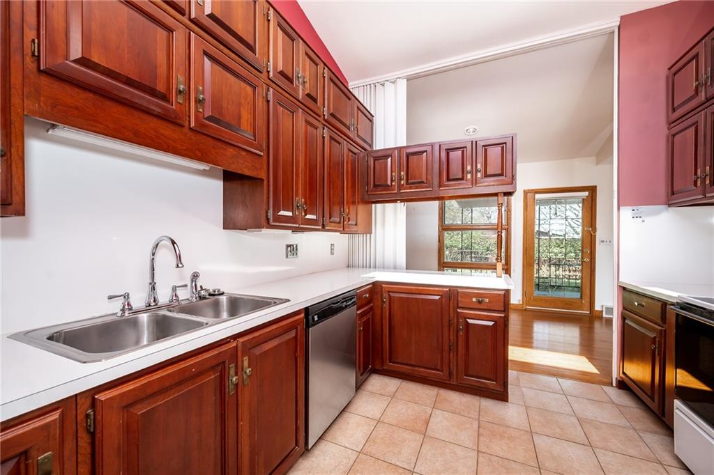 200 Church Avenue Indiana, PA 15701 - Photo 14 of 37 a kitchen with stainless steel appliances granite countertop a sink and dishwasher a refrigerator with wooden cabinets