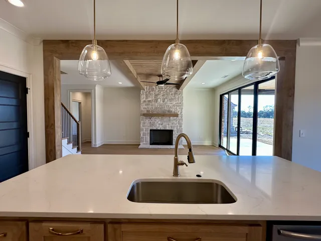 a view of empty room with wooden floor and window