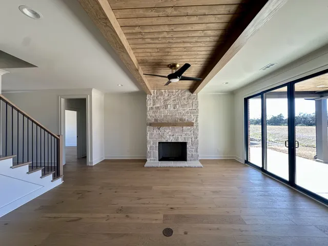 a view of a big room with a big yard and large tree