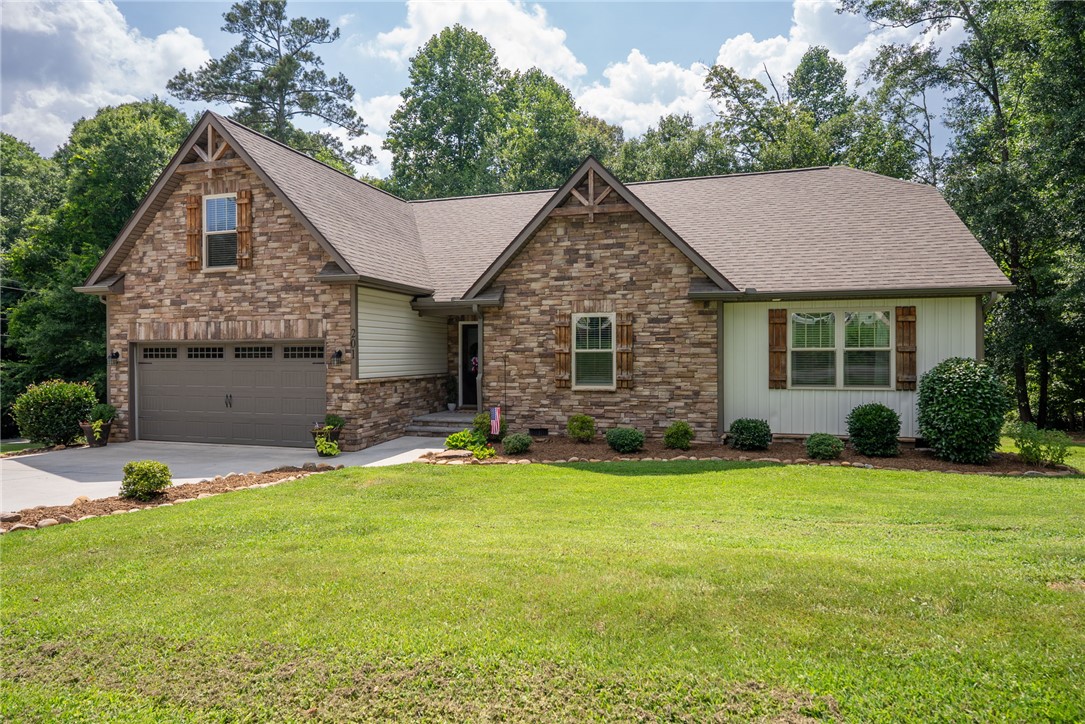 201 Hearthstone Drive Anderson, SC 29621 - Photo 2 of 49 A classic brick and siding residence with a two-car garage and manicured front lawn.