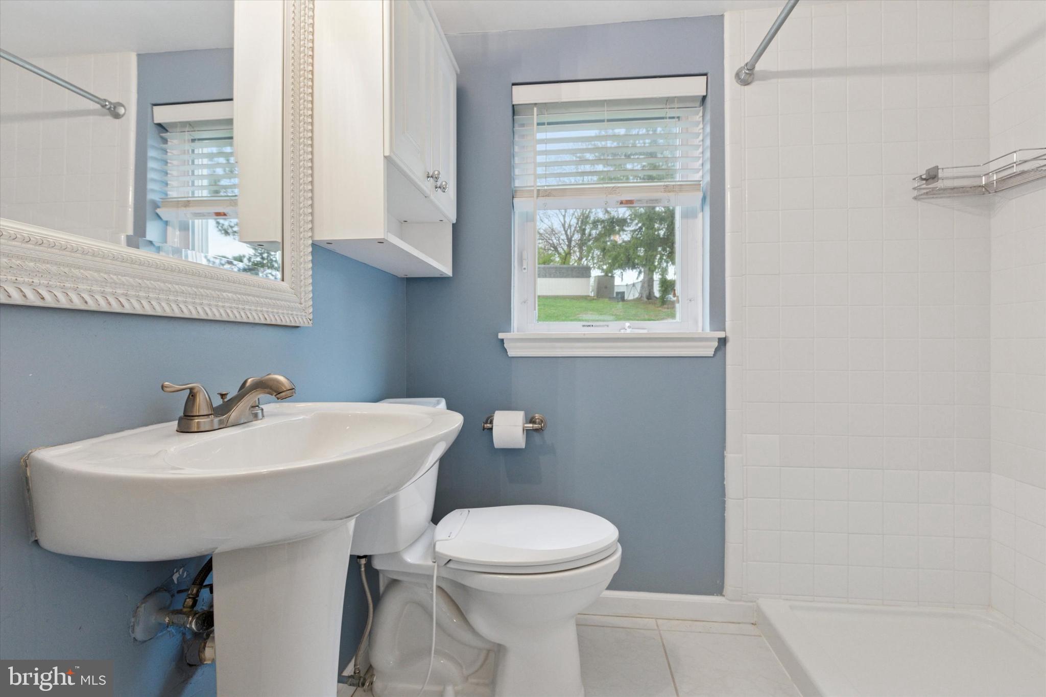 3 Buttonwood Avenue Malvern, PA 19355 - Photo 13 of 25 a bathroom with a sink a toilet and a mirror