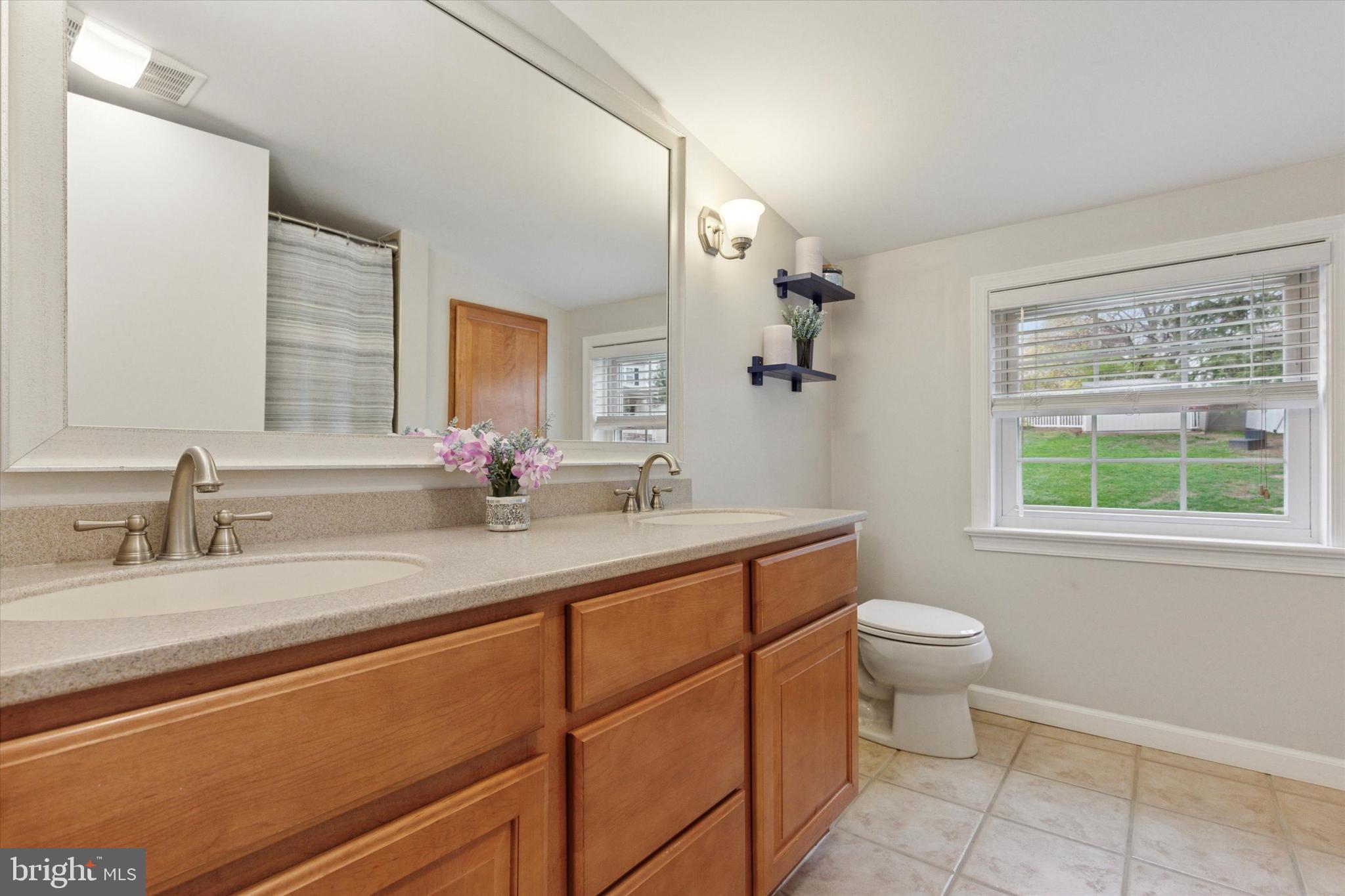3 Buttonwood Avenue Malvern, PA 19355 - Photo 16 of 25 a bathroom with a granite countertop sink a toilet and a mirror