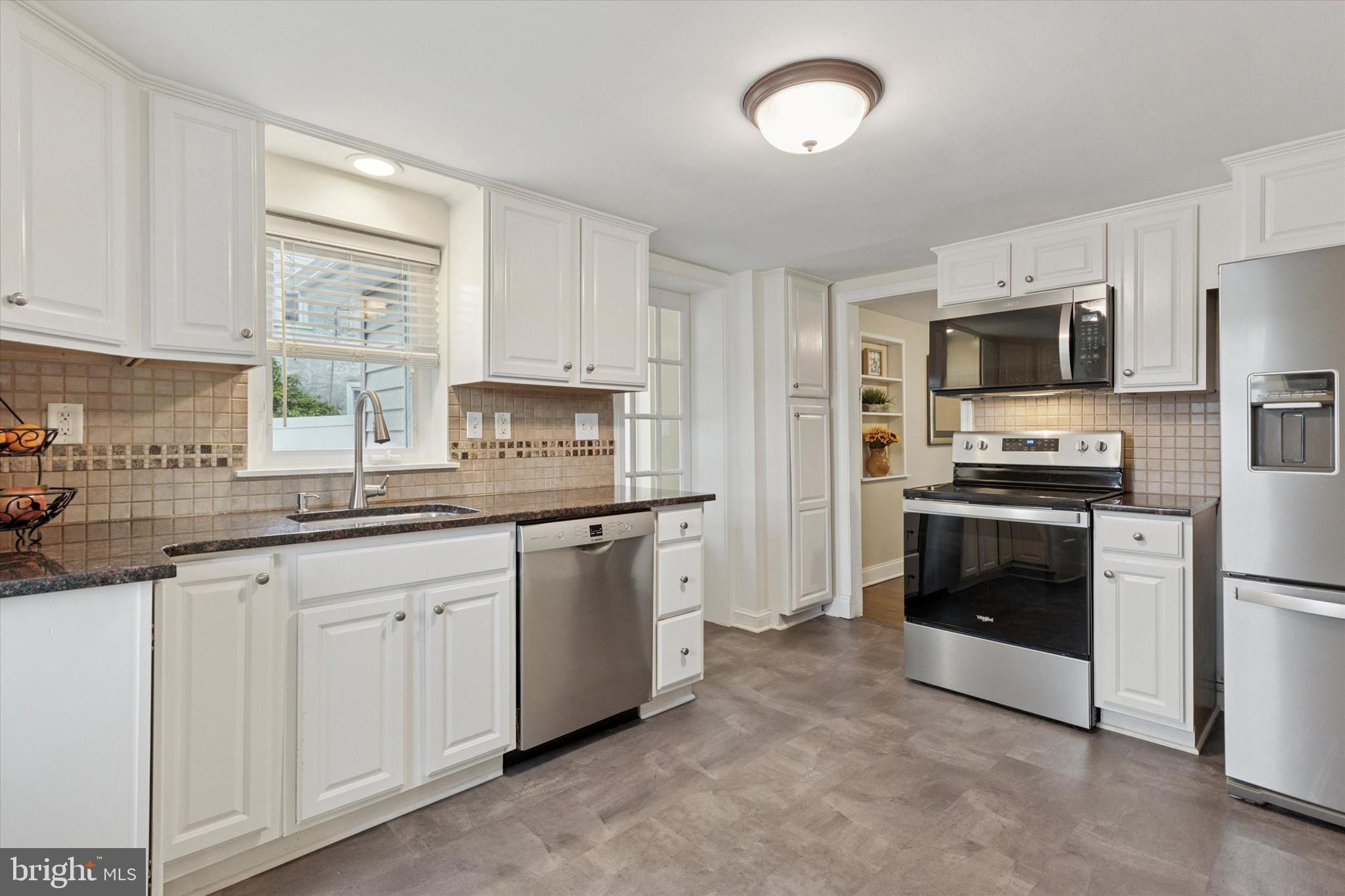 3 Buttonwood Avenue Malvern, PA 19355 - Photo 7 of 25 a kitchen with granite countertop white cabinets and stainless steel appliances
