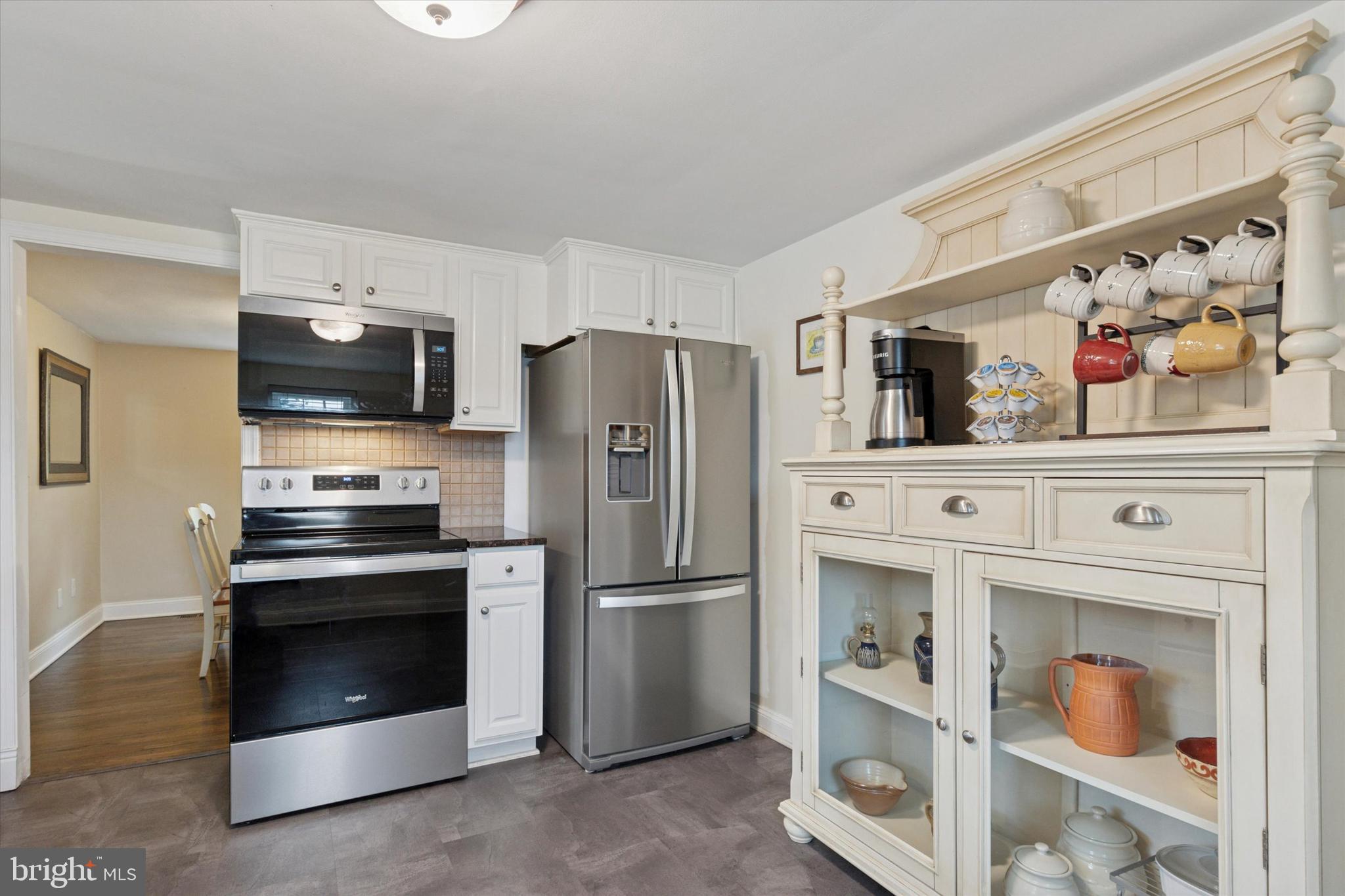 3 Buttonwood Avenue Malvern, PA 19355 - Photo 8 of 25 a kitchen with white cabinets and stainless steel appliances