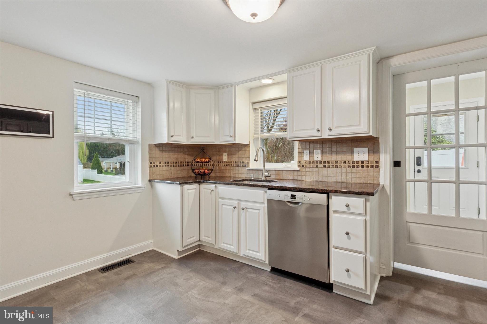 3 Buttonwood Avenue Malvern, PA 19355 - Photo 9 of 25 a kitchen with granite countertop white cabinets and white appliances