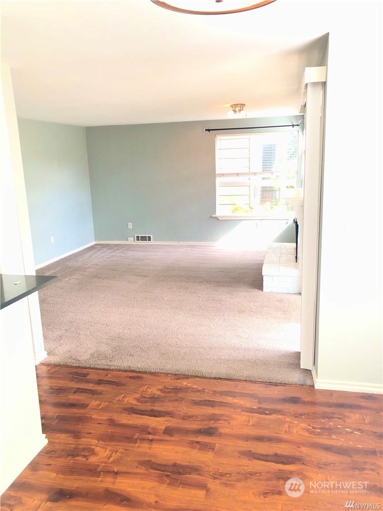 820 Cady Road, Unit B103 Everett, WA 98203 - Photo 1 of 16 a view of room and wooden floor