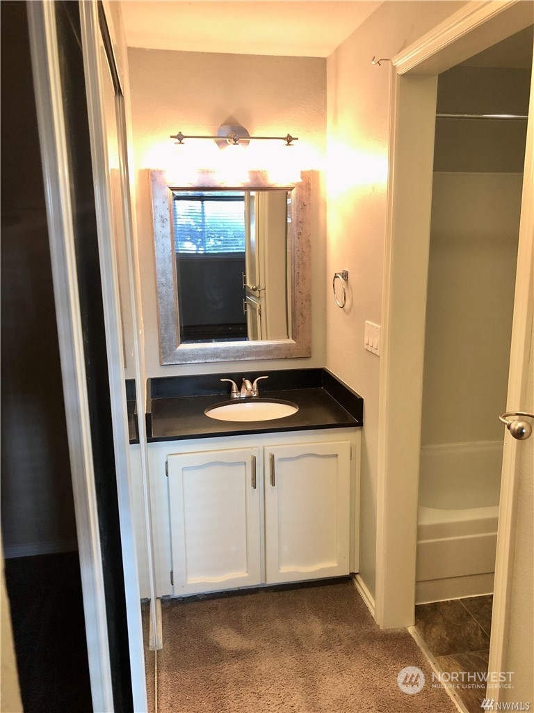820 Cady Road, Unit B103 Everett, WA 98203 - Photo 12 of 16 a bathroom with a sink and a mirror